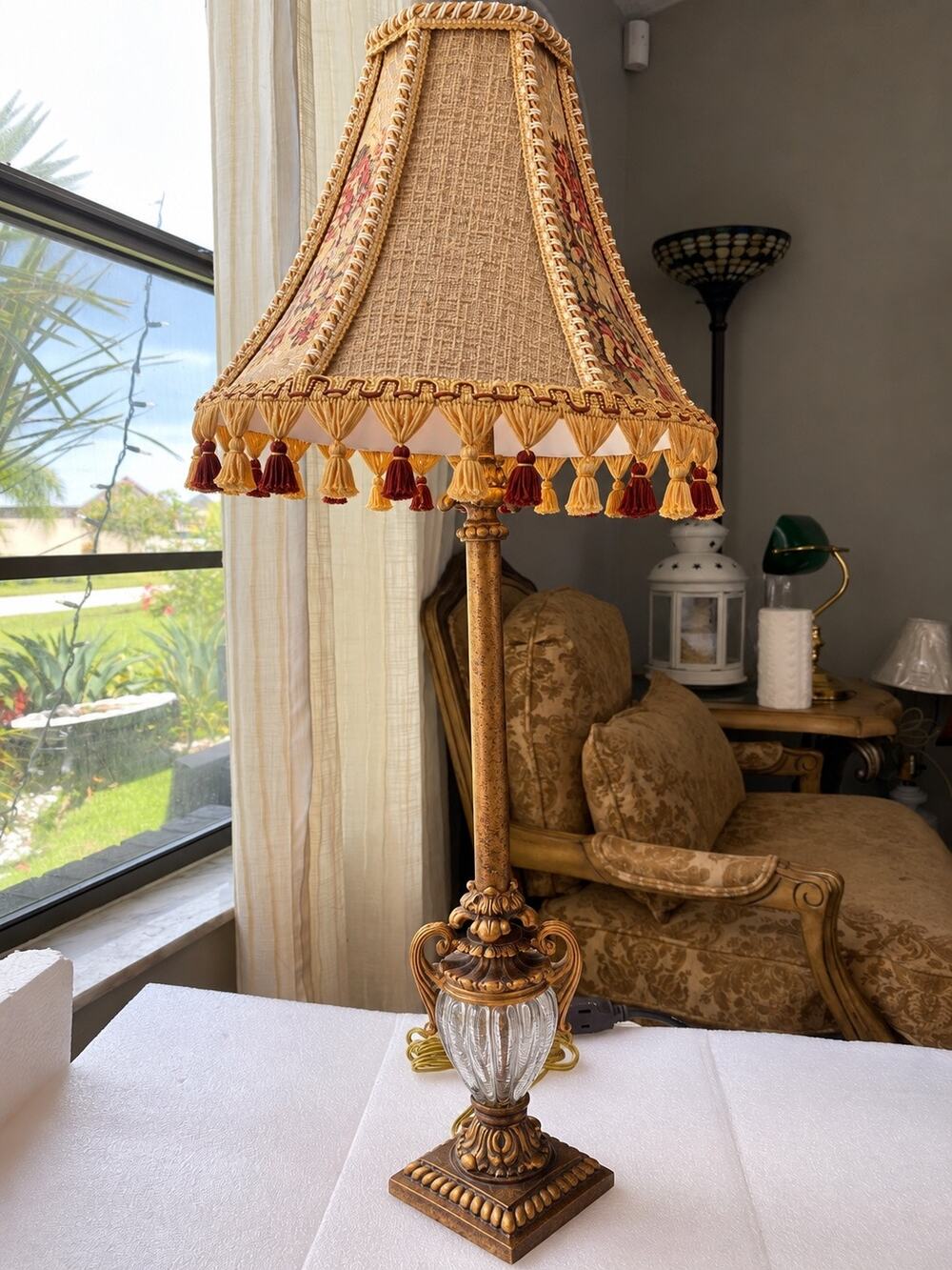 vintage or antique-style table lamp featuring an ornate, golden base crystal